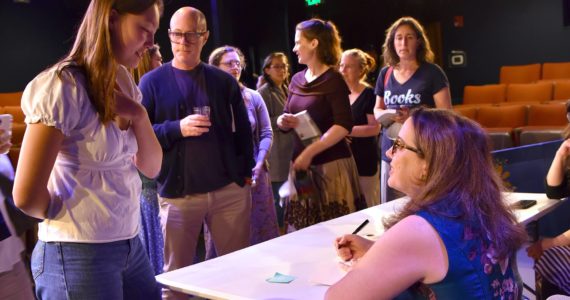 Sydney Sorensen of Bainbridge Island speaks with Julia Quinn during a book signing event in Poulsbo.