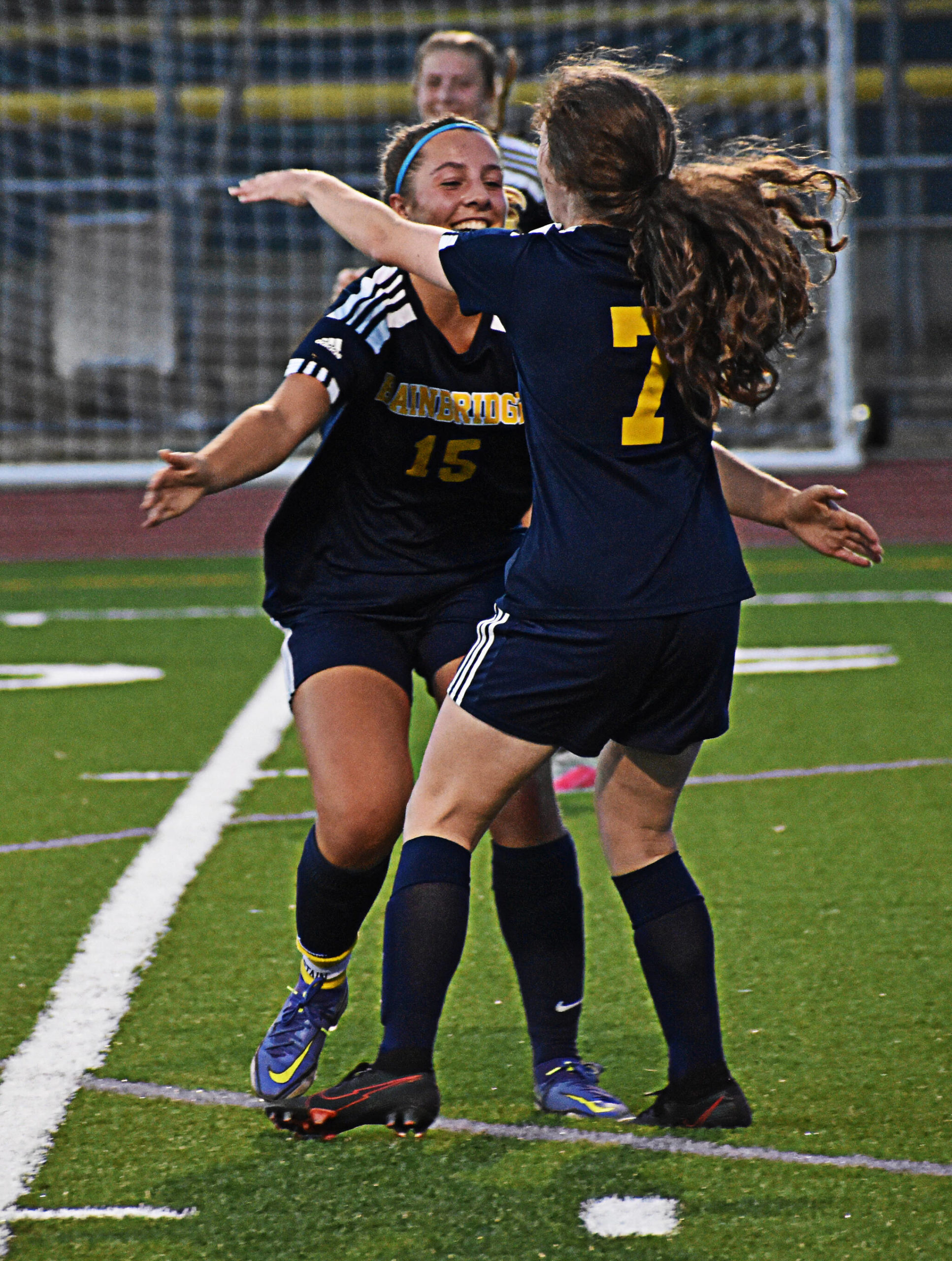 Gabby Weis celebrates with Savannah Mabee after scoring the first of four goals in the game. Nicholas Zeller-Singh/Bainbridge Review Photos