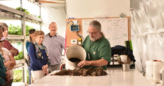 Mark Taylor shows visitors the process he uses to start plants in his hydroponics shed. Nancy Treder/Kitsap News Group Photos