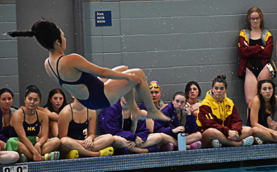 Kingston and North Kitsap gather around Ema Riegel to cheer her on while she performs her dives. Nicholas Zeller-Singh/Kitsap News Group Photos