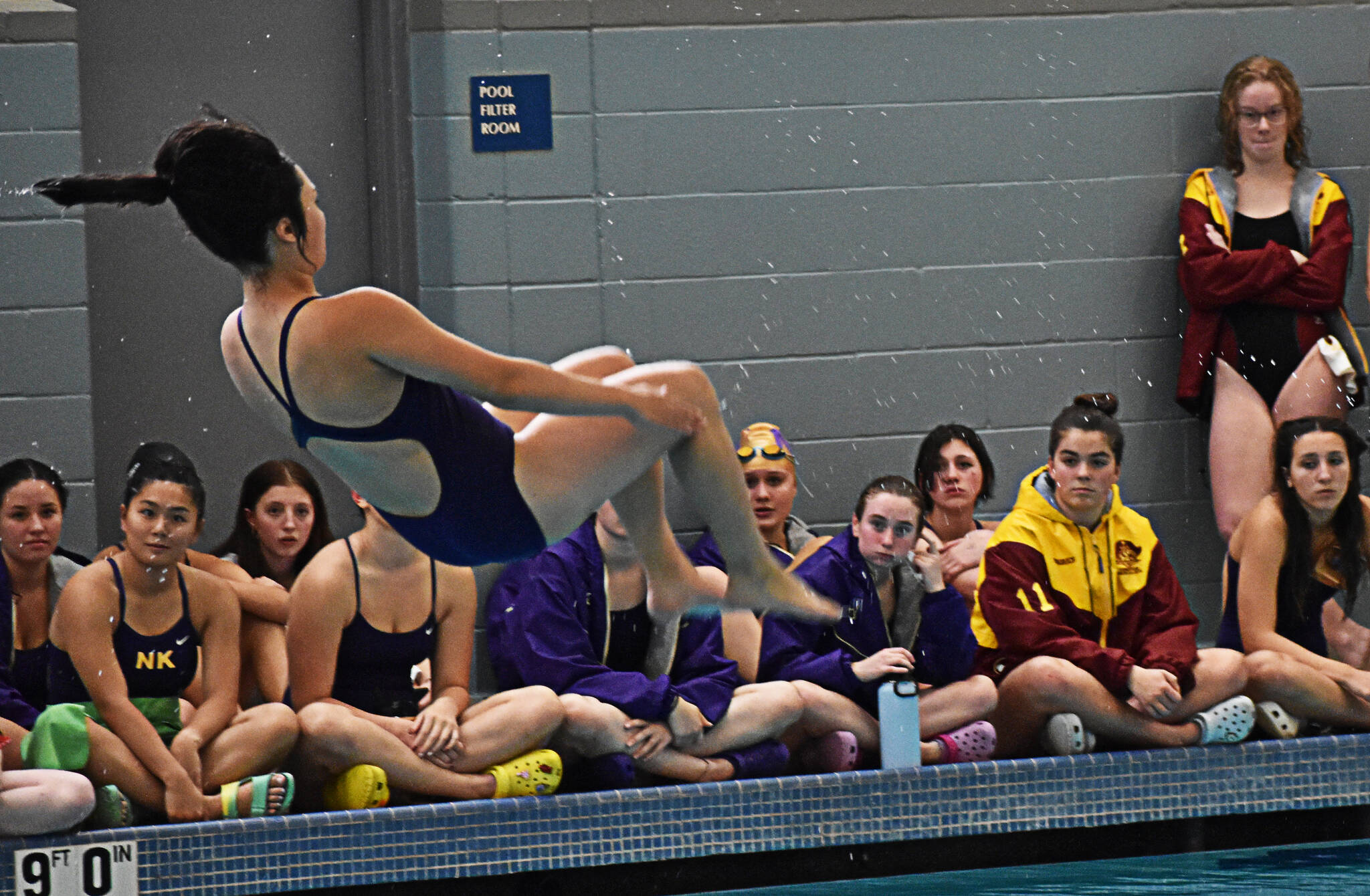Kingston and North Kitsap gather around Ema Riegel to cheer her on while she performs her dives. Nicholas Zeller-Singh/Kitsap News Group Photos