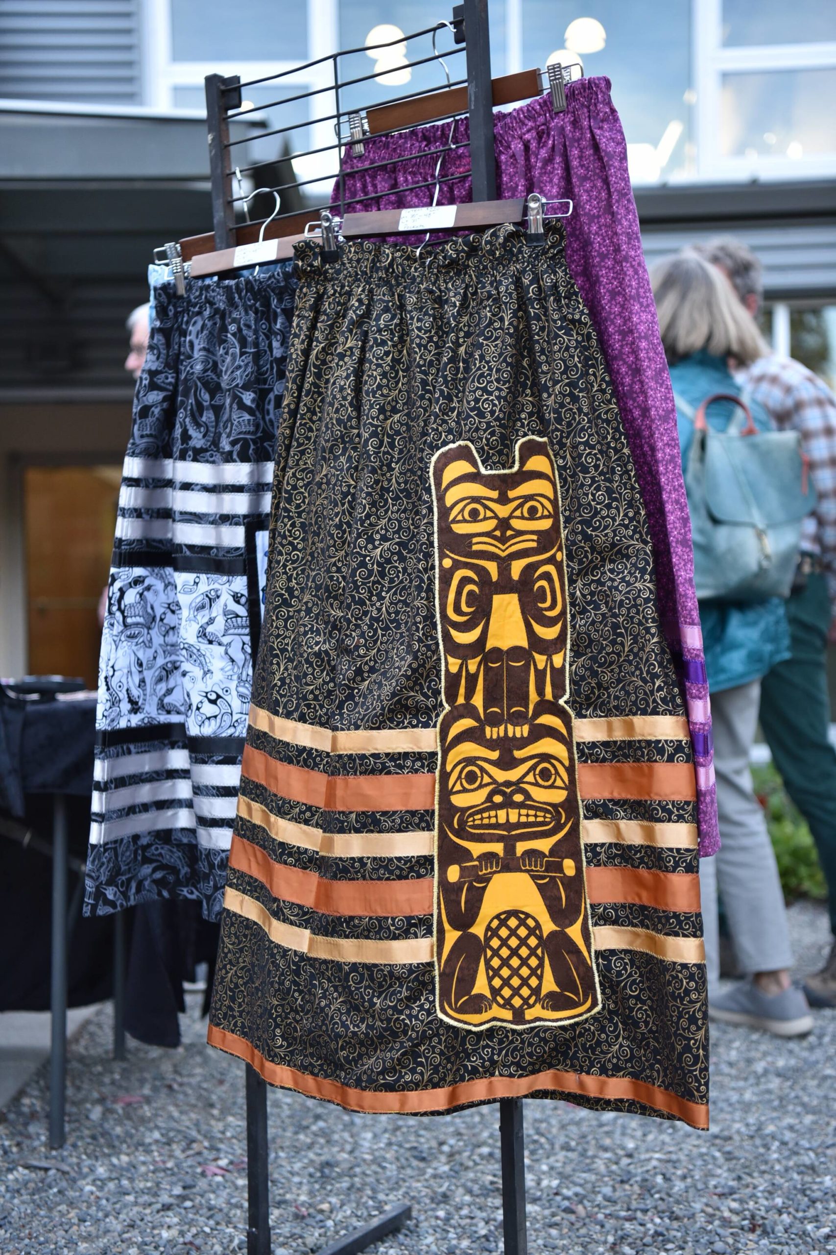 Ribbon skirts on display with a totem applique.