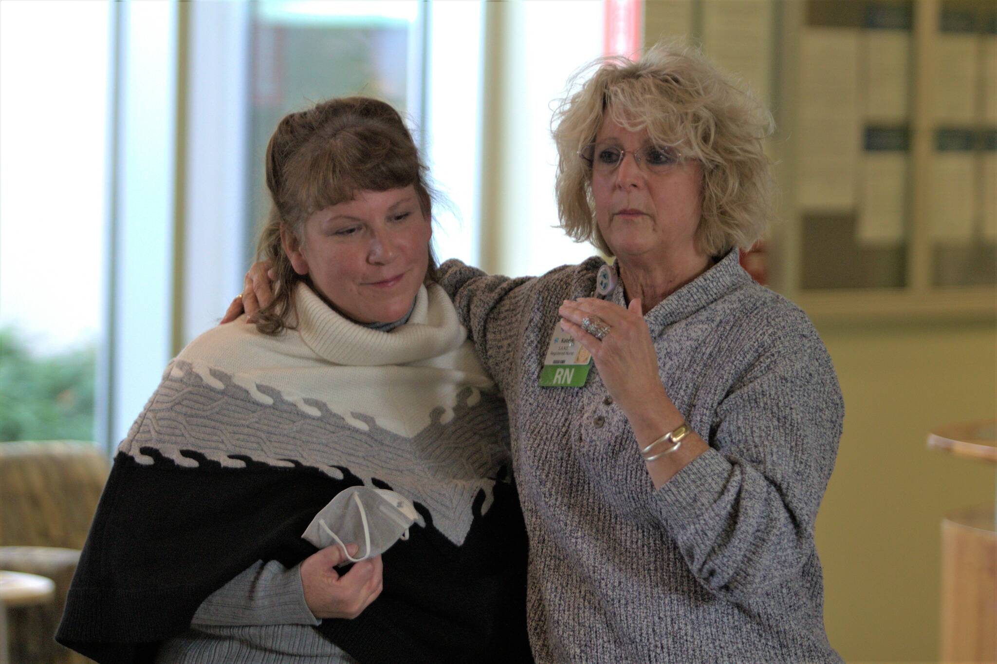 Kate Espy, right, gives remarks next to one of the many people she credited with helping develop the SANE program. Elisha Meyer/Kitsap News Group