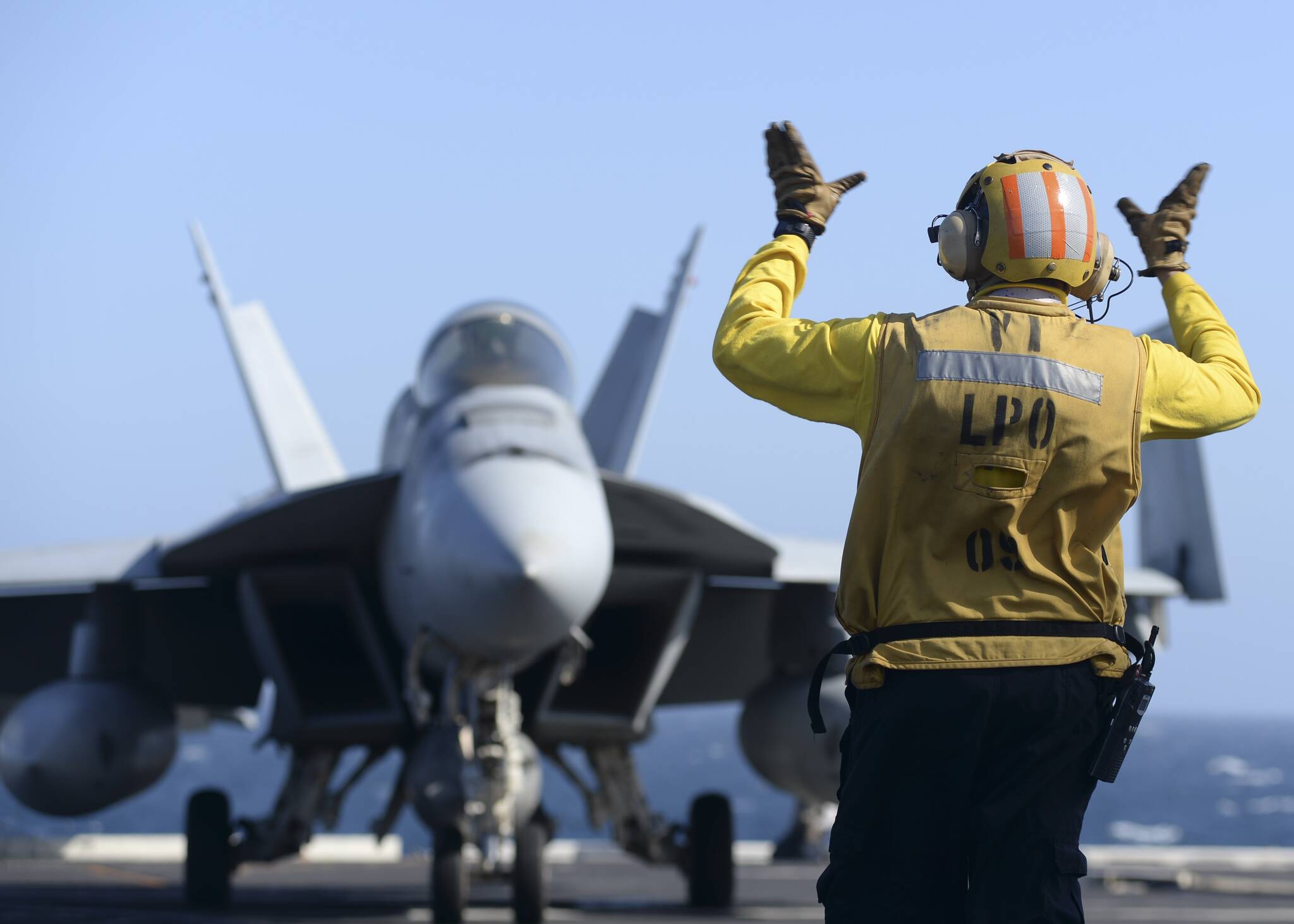 Stanley Sanchez directs an F/A-18E Super Hornet aboard the USS Nimitz. Courtesy Photos
