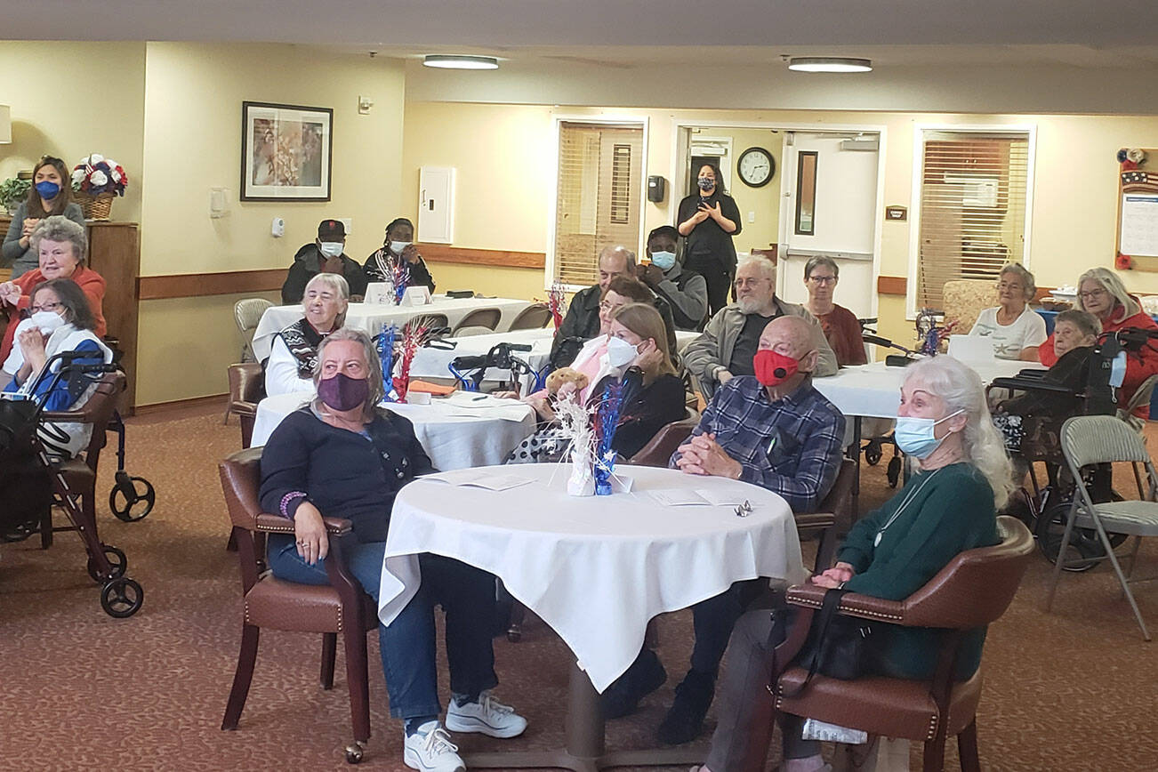 Veterans, friends and family watch the ceremony at Brookdale Montclair senior living facility in Poulsbo Nov. 11.