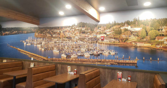 A large picture of Liberty Bay adorns one of the walls above seating booths. Tyler Shuey/Kitsap News Group Photos