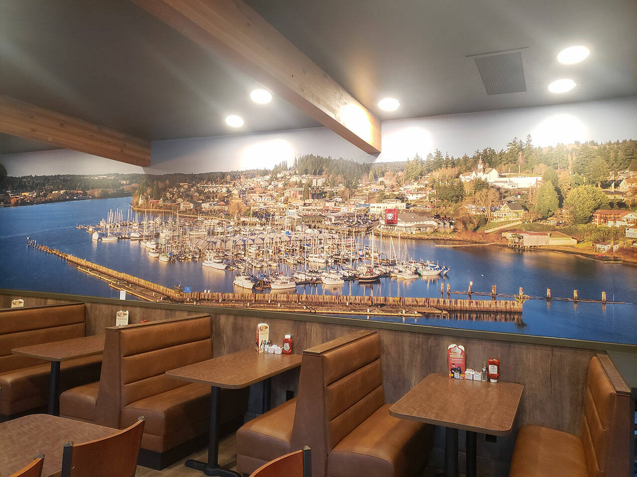 A large picture of Liberty Bay adorns one of the walls above seating booths. Tyler Shuey/Kitsap News Group Photos