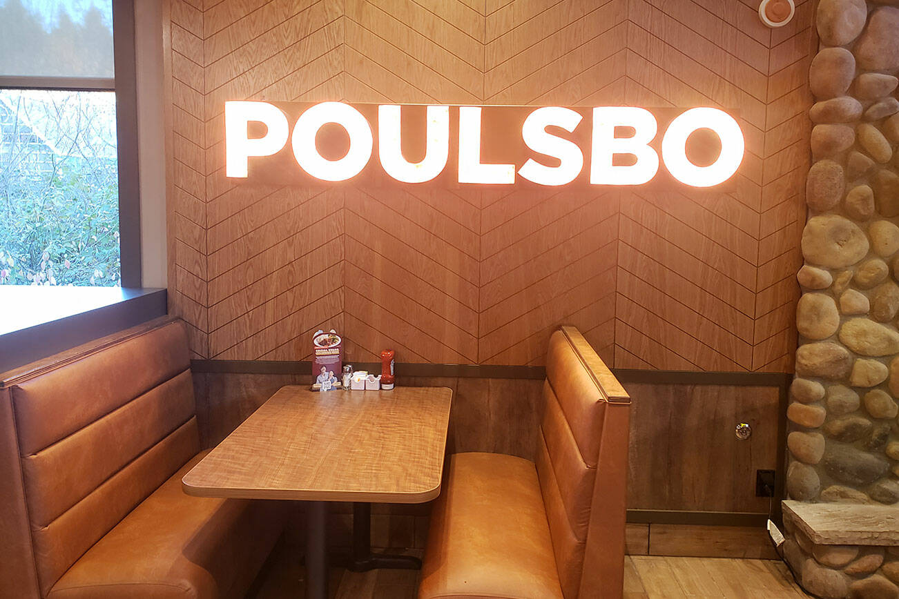 A vibrant Poulsbo sign above one of the booth’s at Denny’s.