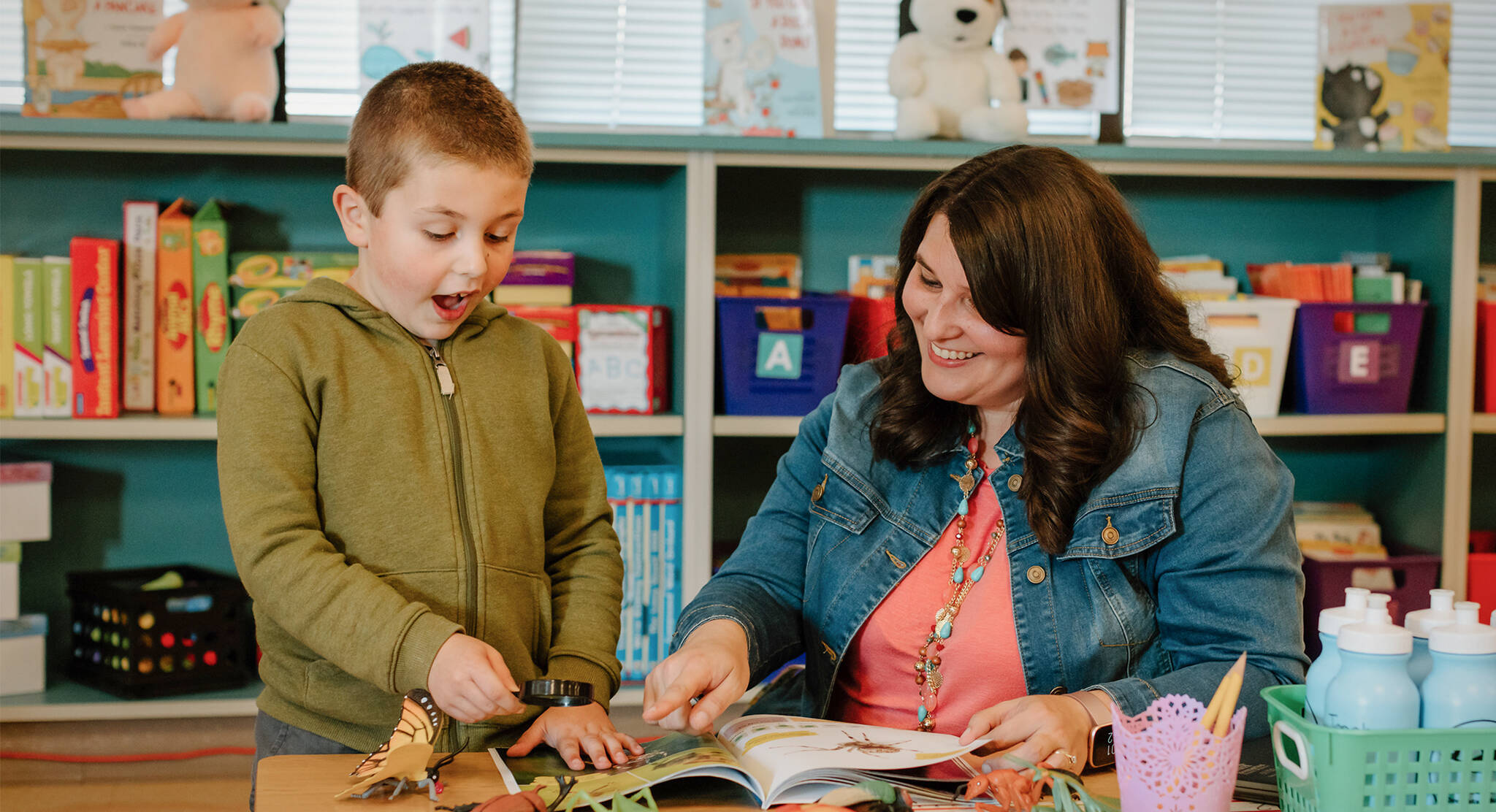 Ashleigh Shiano-Oliver explores a book with Daniel. Courtesy Photo