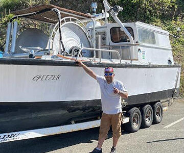 Duran George with his boat 'The Geezer.' Courtesy Photos