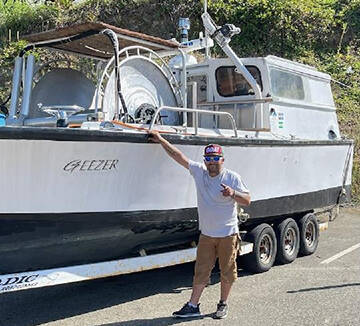 Duran George with his boat 'The Geezer.' Courtesy Photos