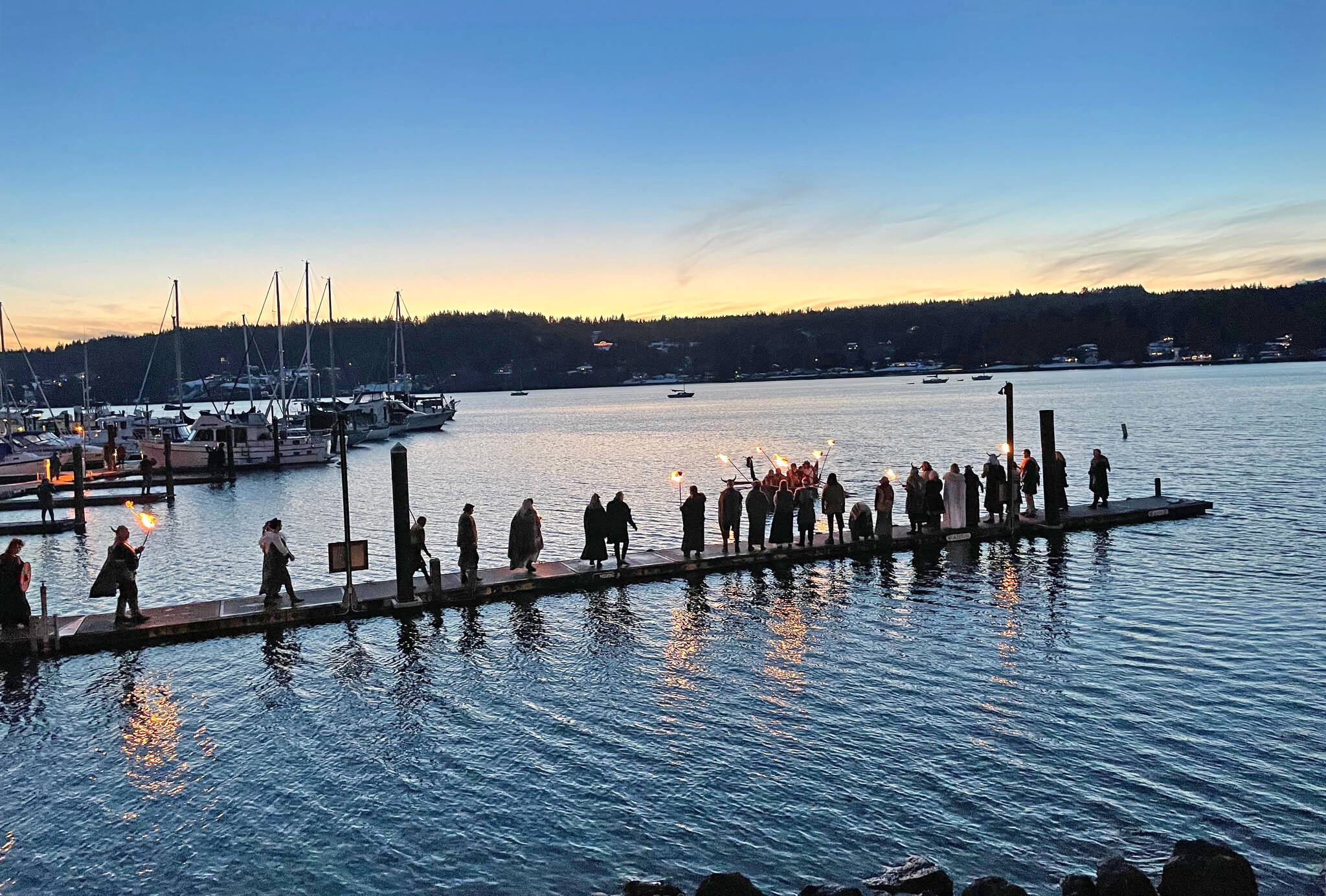 A procession of Vikings waits for the Lucia Bride to arrive at Liberty Bay Dec. 3 in Poulsbo.
