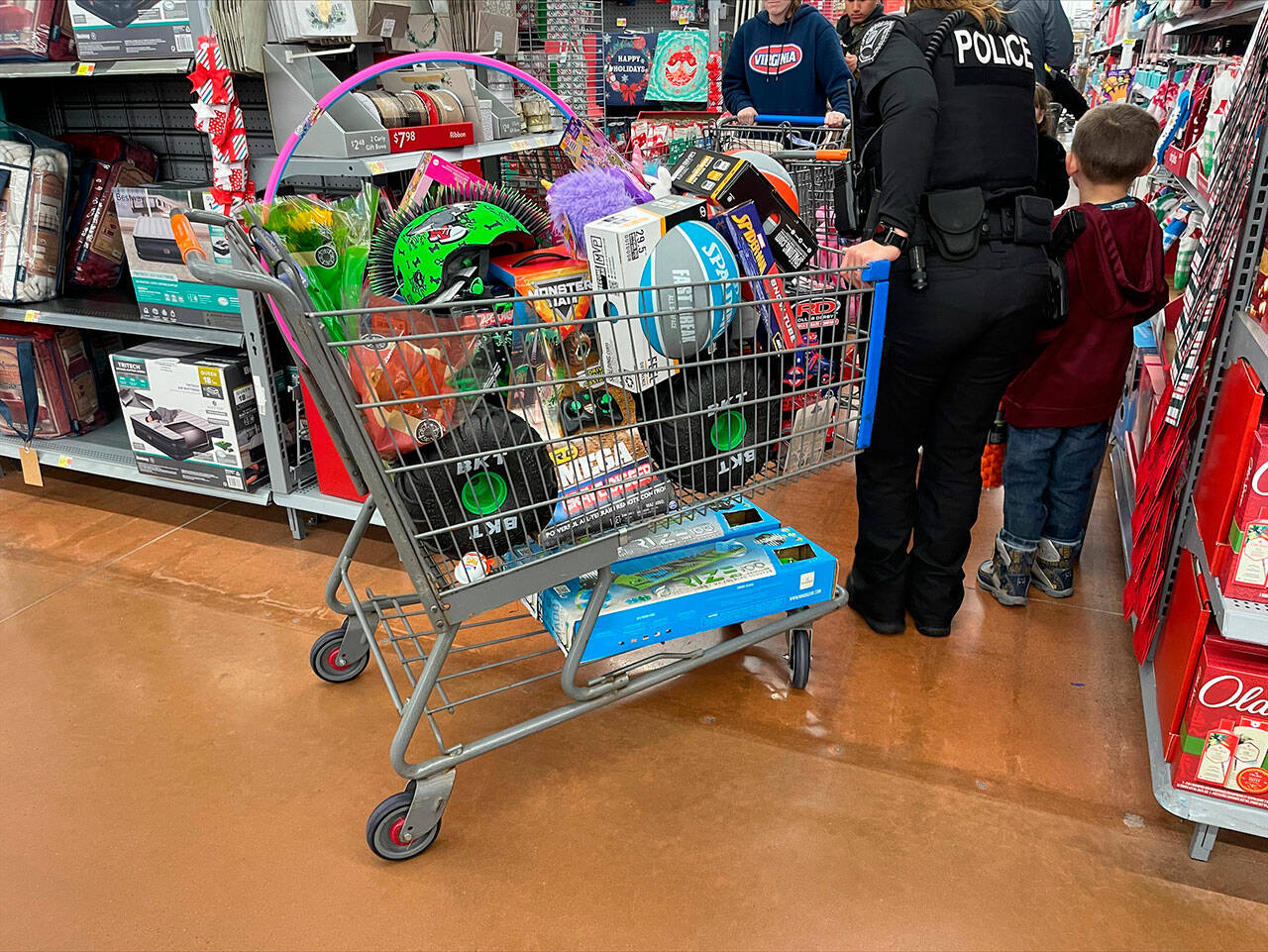 Police shop for presents with children at the Poulsbo Walmart Dec. 3. Courtesy Photos