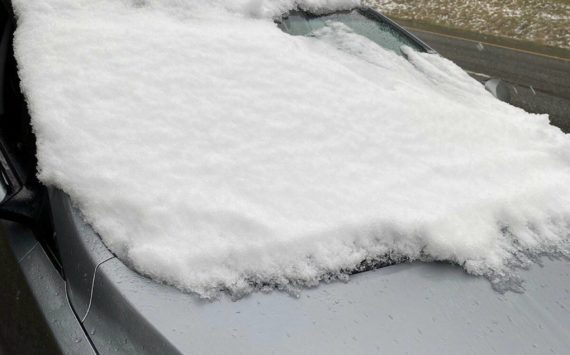 Aside from a small corner, the windshield and top of the car are packed with snow and ice. Courtesy Photo