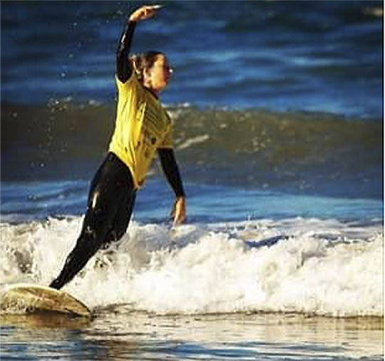 Sarah Dean of Bainbridge has been an avid surfer before and after her accident and amputation. Photos courtesy of Sarah Dean