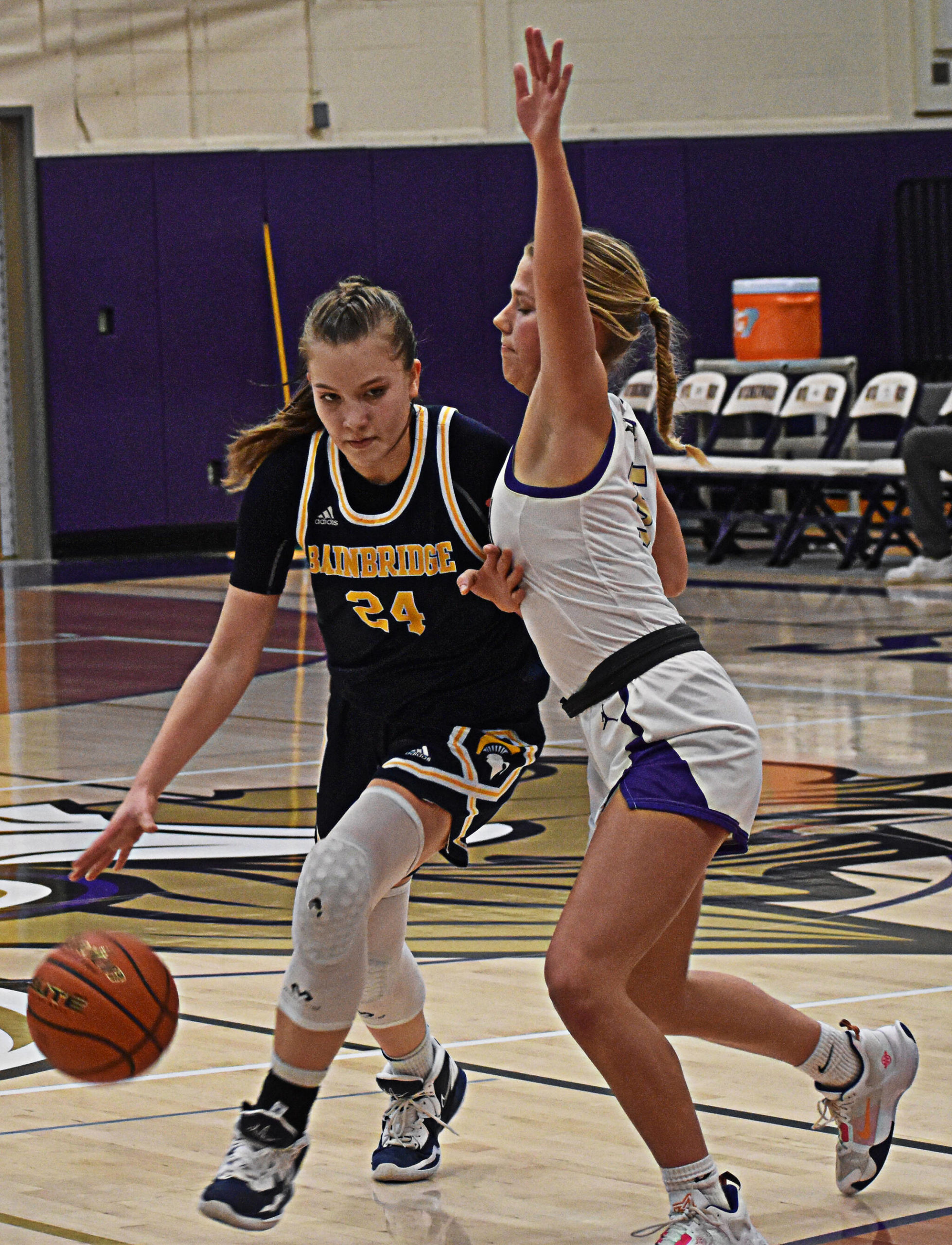 Bella Ramirez of the Spartans drives to the basket with NK’s Evelyn Beers guarding closely. Nicholas Zeller-Singh/Kitsap News Group Photos