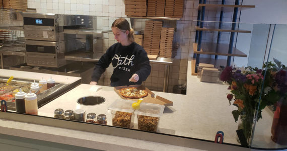Emily Langford, daughter of owners Brad and Jennifer, prepares a pizza at the newly opened Oath Pizza in Poulsbo. Tyler Shuey/Kitsap News Group Photos