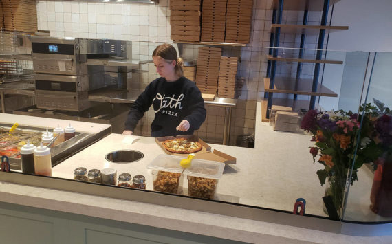 Emily Langford, daughter of owners Brad and Jennifer, prepares a pizza at the newly opened Oath Pizza in Poulsbo. Tyler Shuey/Kitsap News Group Photos