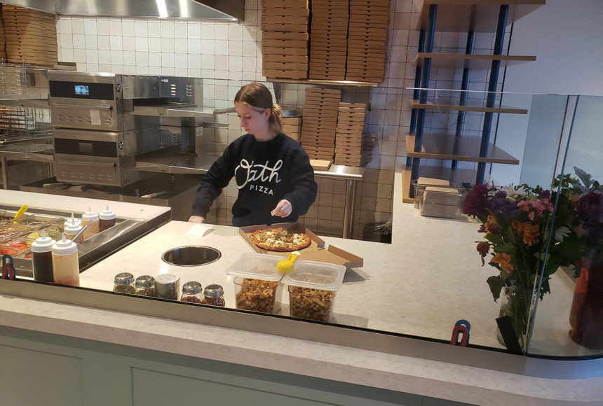 <p>Emily Langford, daughter of owners Brad and Jennifer, prepares a pizza at the newly opened Oath Pizza in Poulsbo. Tyler Shuey/Kitsap News Group Photos</p>