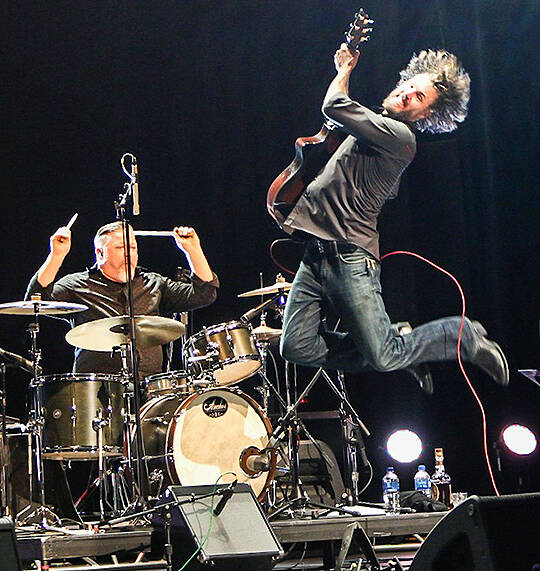 Thys Wallwork goes airborne in front of Kevin Blackwood during Skinny Blue’s 2021 Admiral Theatre performance. Courtesy of Erik Morgensen Photography and the Admiral Theatre Foundation