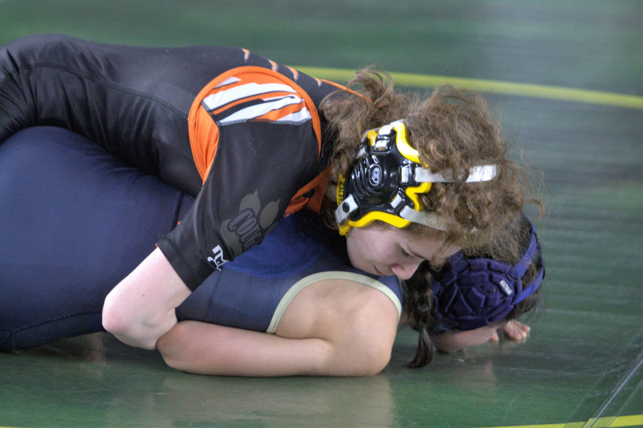 Angel Cartagena looks to pin her opponent.