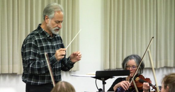 Conductor Alan Futterman leads the orchestra in a rehearsal for the anniversary concert. Elisha Meyer/Kitsap News Group