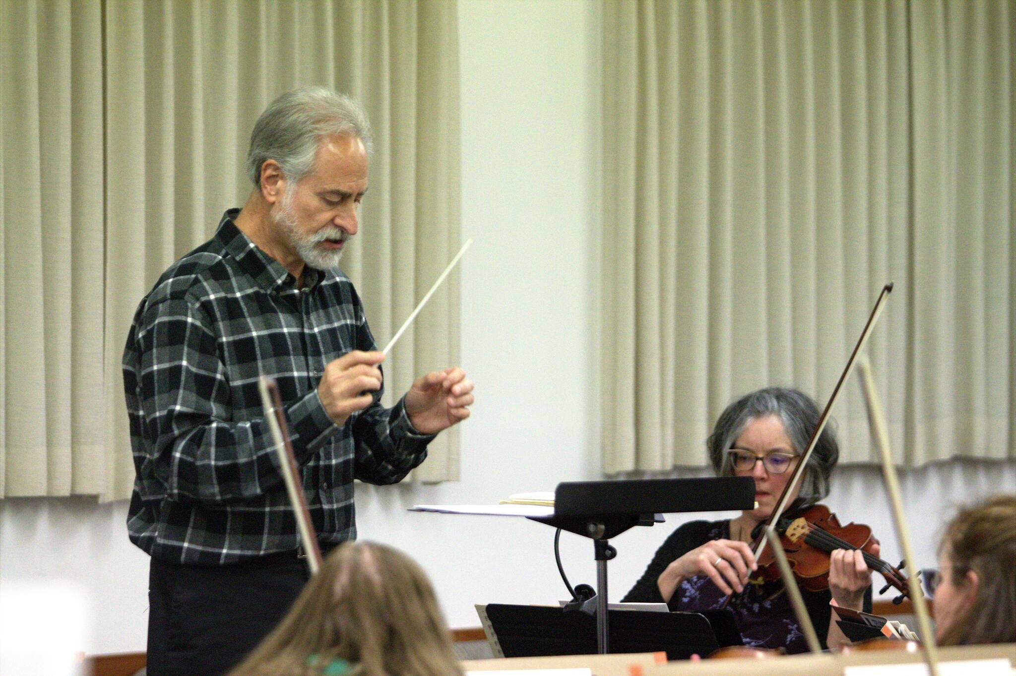 Conductor Alan Futterman leads the orchestra in a rehearsal for the anniversary concert. Elisha Meyer/Kitsap News Group