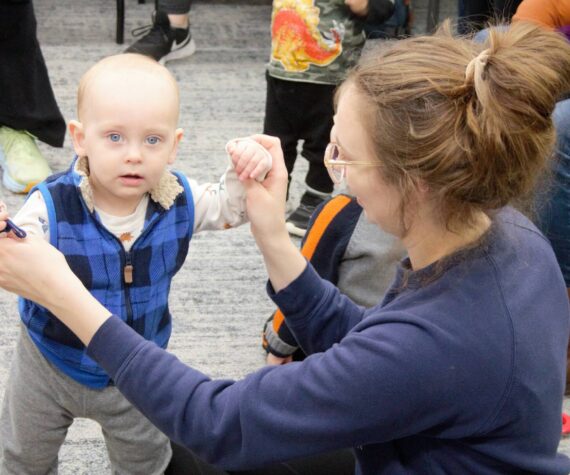 Elisha Meyer/Kitsap News Group Photos
A mom plays with her child, who is holding a bell instrument, during a morning Baby Band activity.