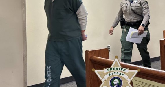 Shaun Rose walks handcuffed through the courtroom accompanied by law enforcement. Kitsap County Sheriff’s Office courtesy photo