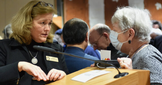 State Sen. Christine Rolfes speaks with a constituent after the Town Hall meeting. Nancy Treder/Kitsap News Group photos