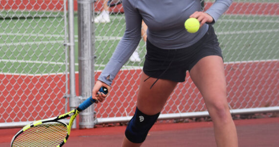 Bainbridge’s Cece Combs looks to return the ball to her opponent. Nicholas Zeller-Singh/Kitsap News Group Photos