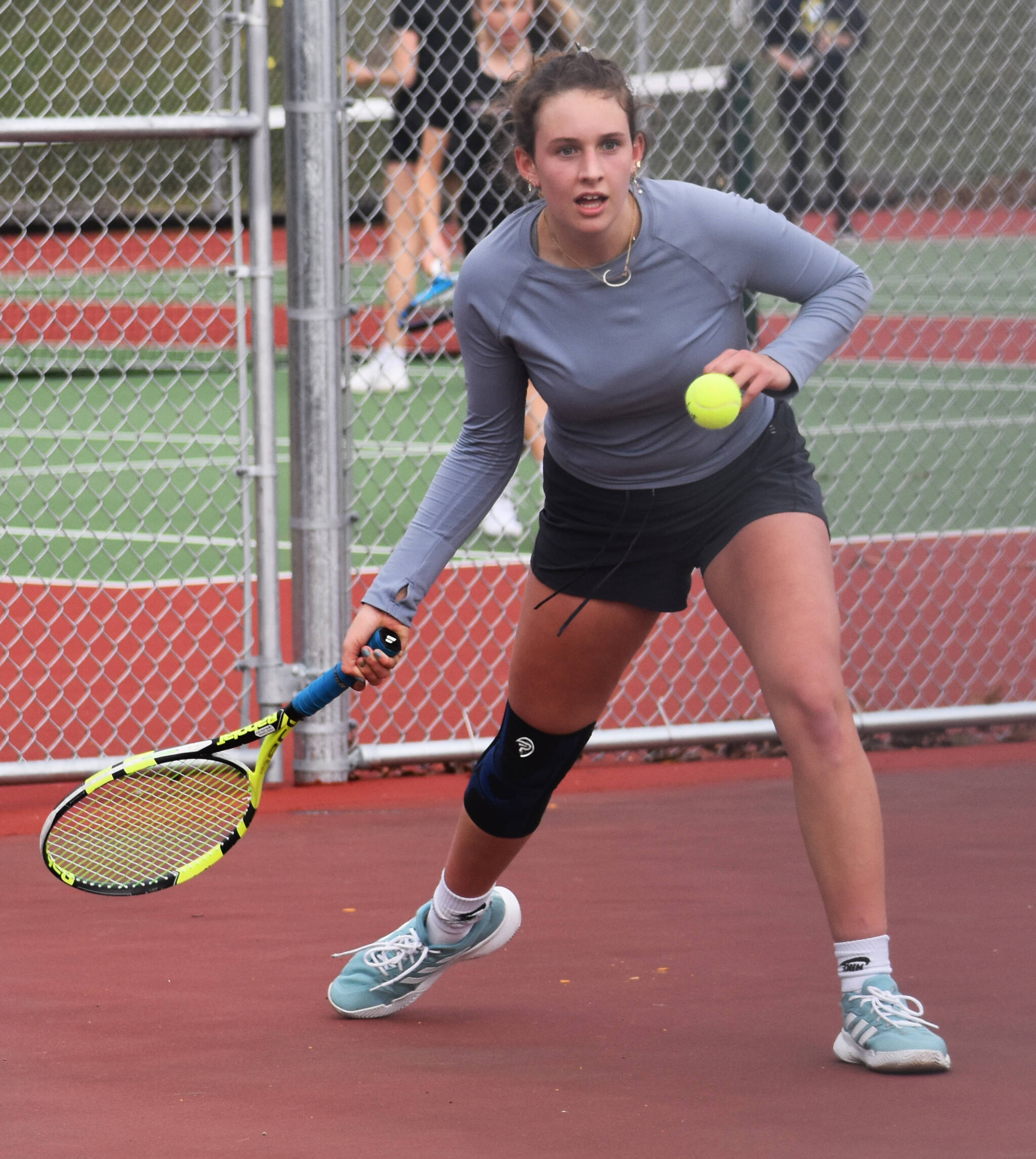 Bainbridge’s Cece Combs looks to return the ball to her opponent. Nicholas Zeller-Singh/Kitsap News Group Photos