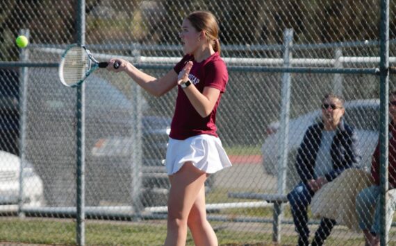 Junior Hailey Deese keeps the rally going with a forehand shot towards her opponent. Elisha Meyer/Kitsap News Group