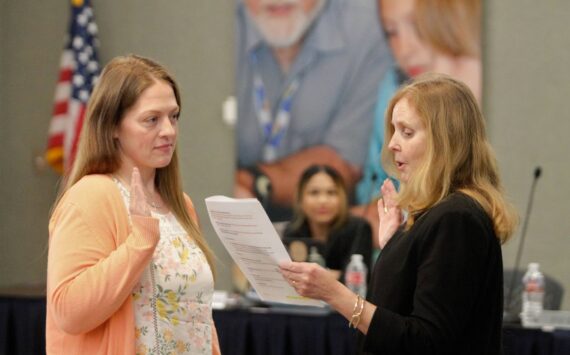 Kristin Hay (left) takes the oath of office before her fellow board directors March 22. Elisha Meyer/Kitsap News Group