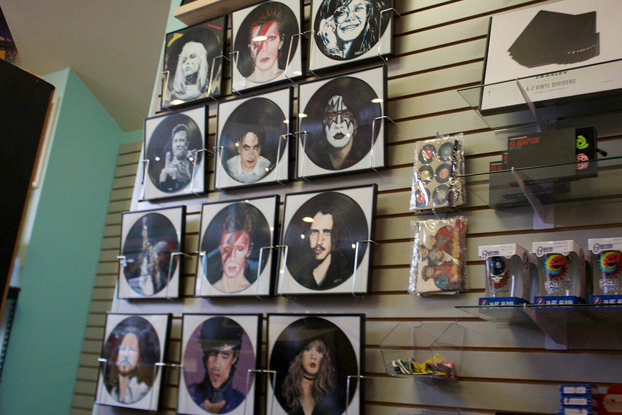 Paintings of famous musicians on vinyl records.