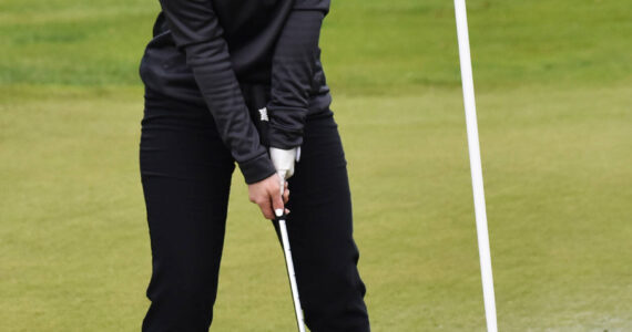 North Kitsap’s Calia Corden putts through a puddle to finished the second hole. Nicholas Zeller-Singh/Kitsap News Group Photos