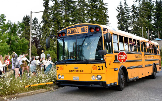 A bus driver takes a group of 2022 Bainbridge High School graduates for a spin around the Madison Avenue and High School Road roundabout on their way to Grad Night festivities. File Photo