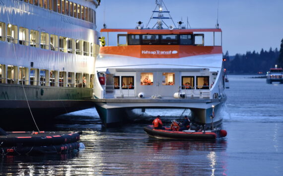 A Kitsap foot ferry parked alongside the Walla Walla to load passengers and take them to Bremerton. Nancy Treder/Kitsap News Group Photos