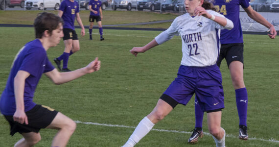 North Kitsap's Harper Sabari dribbles around a Wolve defender in their game April 25 in Sequim. The Vikings picked up a 2-0 victory. Emily Matthiessen/Sequim Gazette