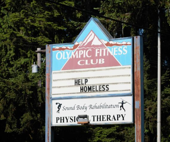 The sign of the old Olympic Fitness Club reads "Help Homeless" Elisha Meyer/Kitsap News Group Photos