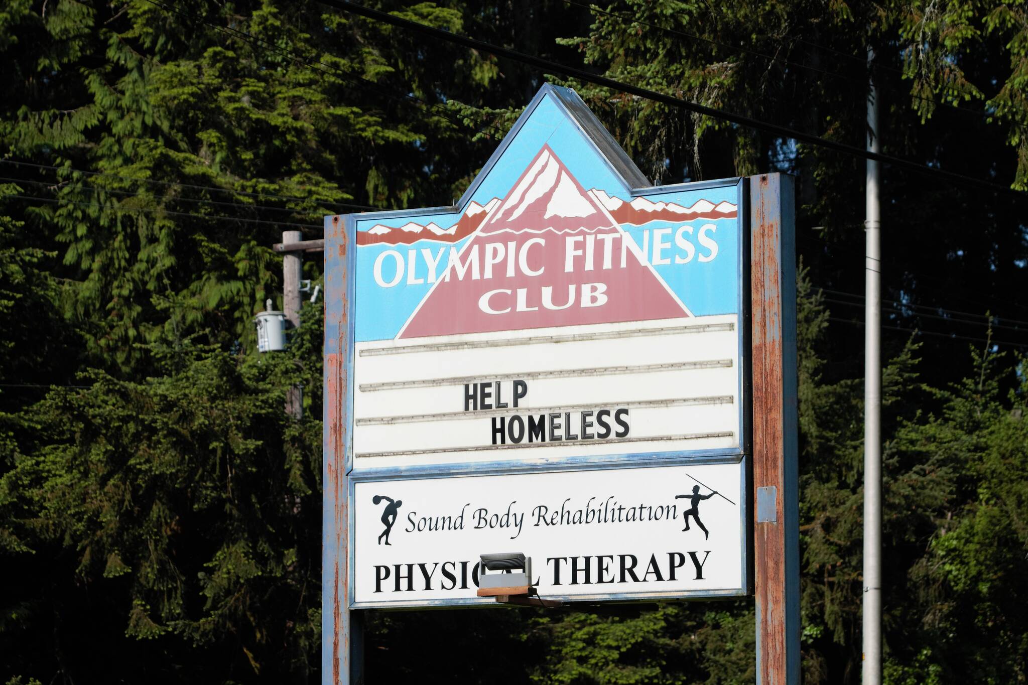 The sign of the old Olympic Fitness Club reads "Help Homeless" Elisha Meyer/Kitsap News Group Photos