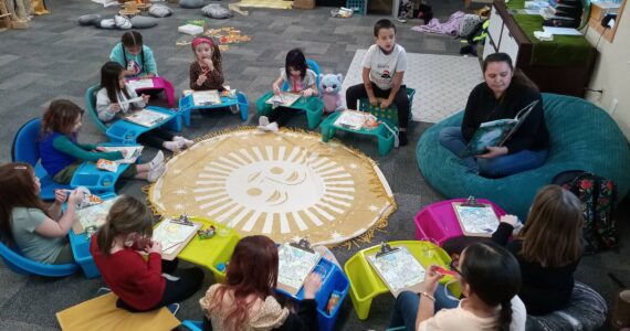 Lauren Moon, S'Klallam volunteer, reads a cultural book during story time. Port Gamble S'Klallam Tribe courtesy photos