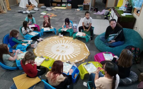 Lauren Moon, S'Klallam volunteer, reads a cultural book during story time. Port Gamble S'Klallam Tribe courtesy photos