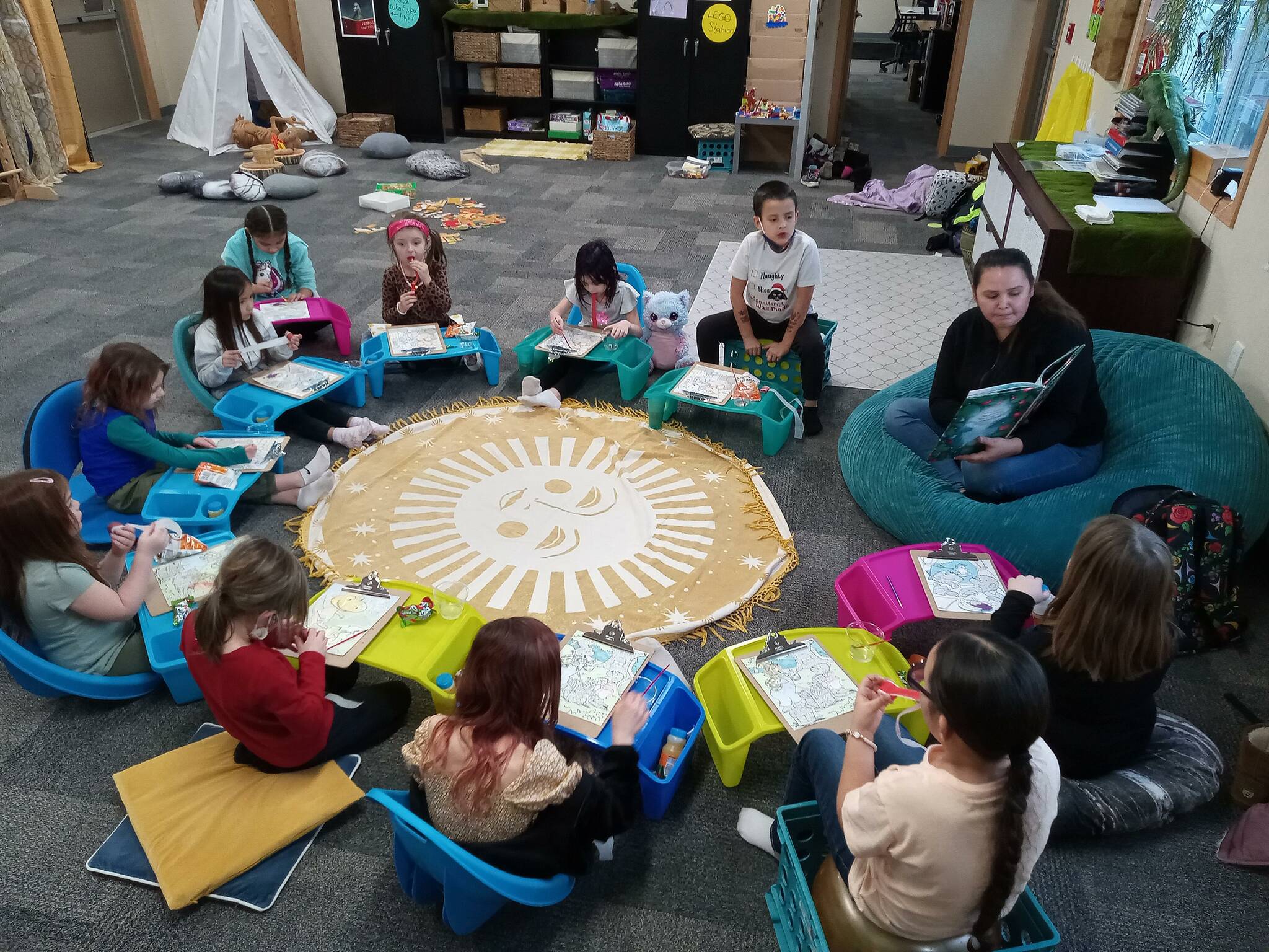 Lauren Moon, S'Klallam volunteer, reads a cultural book during story time. Port Gamble S'Klallam Tribe courtesy photos