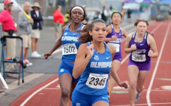 Elisha Meyer/Kitsap News Group 
Senior sprinter from Olympic High School N’Dya Hudson (back) approaches her senior teammate Aalliya Alcorn (front) for a baton handoff in the 4x200-meter relay.