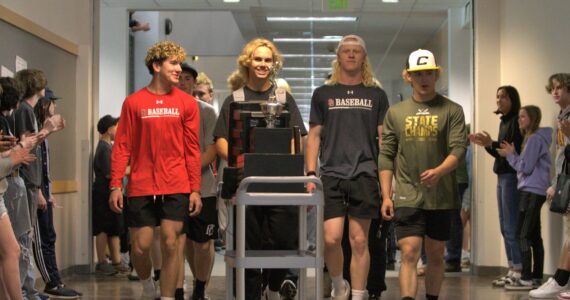 Elisha Meyer/Kitsap News Group 
The Klahowya baseball team parades down the school hall surrounded by applauding students and faculty one week after the team claimed a state championship.