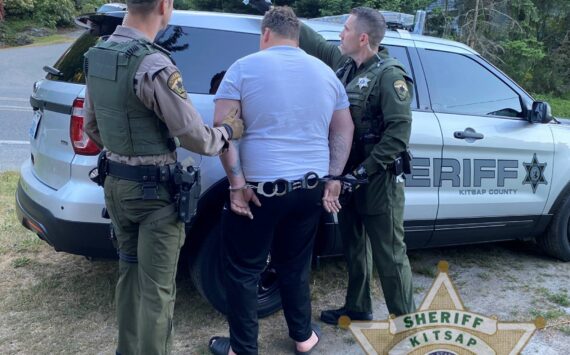 The suspect is arrested and led to a Kitsap County Sheriff’s Office vehicle by law enforcement. KCSO courtesy photo