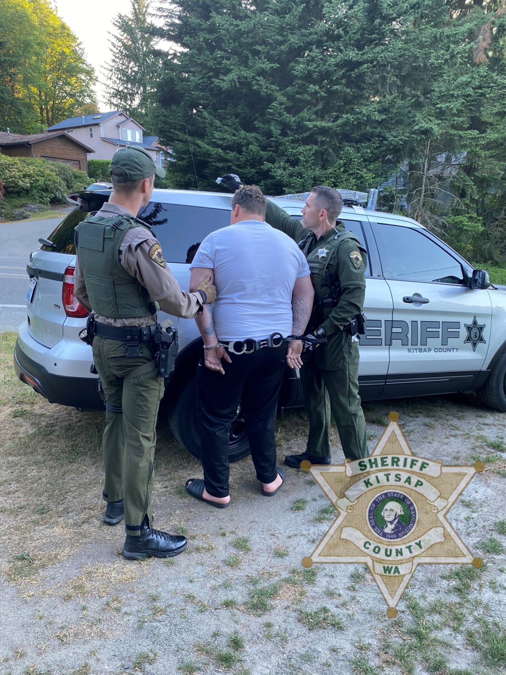 The suspect is arrested and led to a Kitsap County Sheriff’s Office vehicle by law enforcement. KCSO courtesy photo