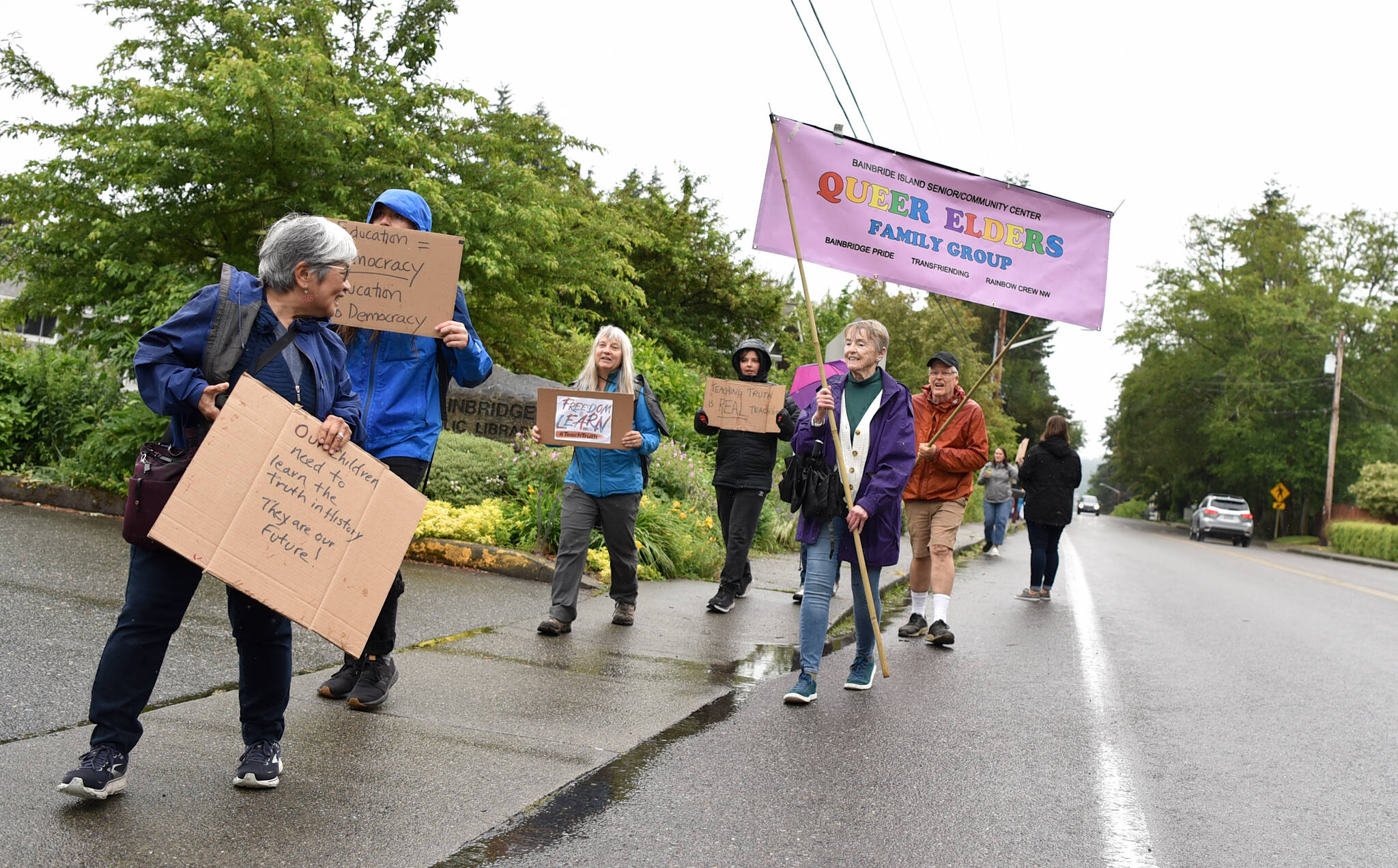 Activists carry a banner in support of queer elders.