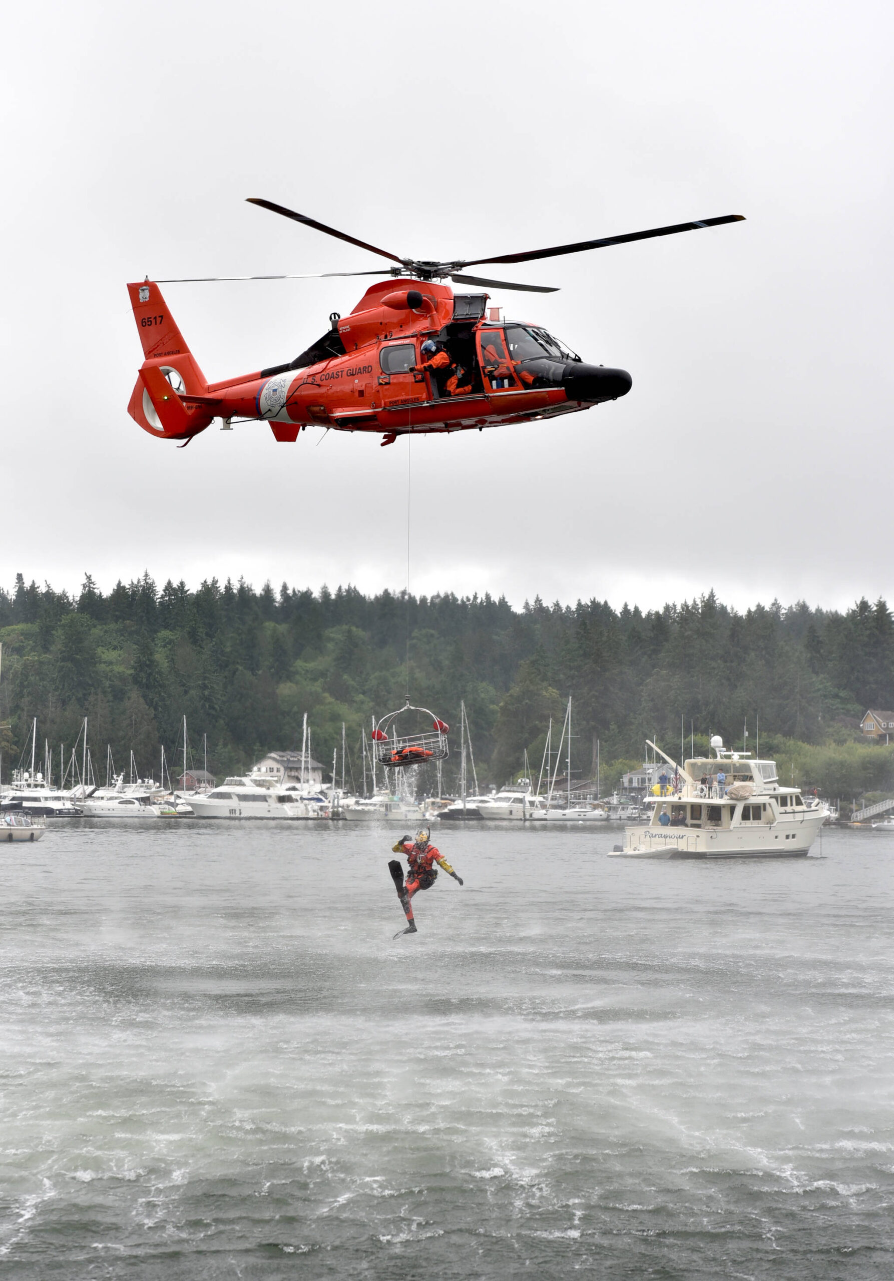 A U.S. Coast Guard diver falls from a rescue litter during a demonstration in Eagle Harbor during the annual Boater's Fair at Waterfront Park June 10. Nancy Treder/Kitsap News Group Photos